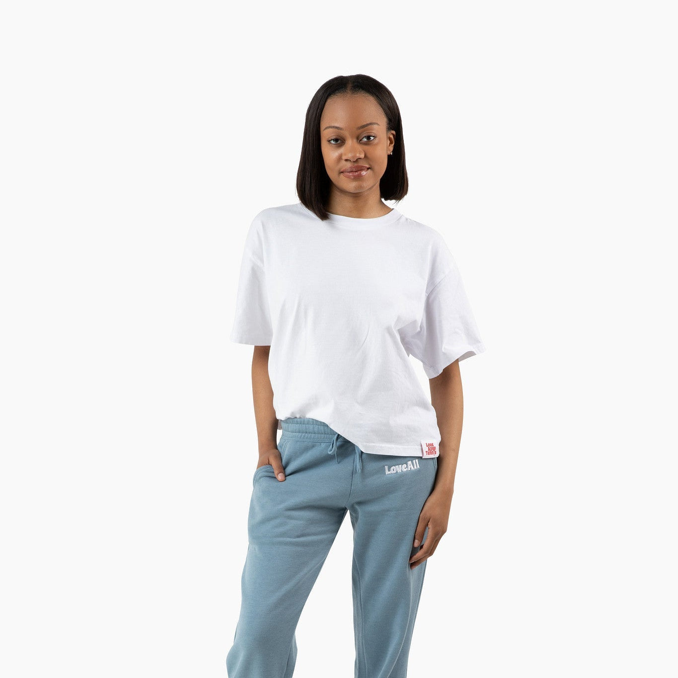 Person wearing a white t-shirt and light blue sweatpants on a white background