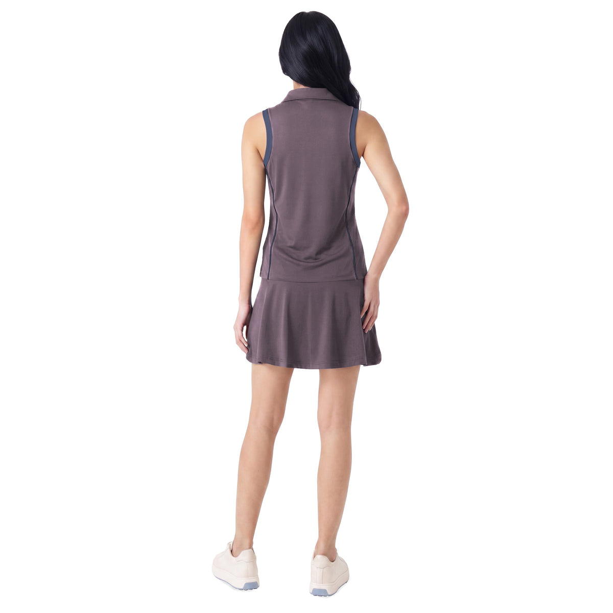 A woman shown from the back wearing a sleeveless, collared athletic top and skirt in a muted taupe-brown color, paired with white sneakers, against a plain white background.
