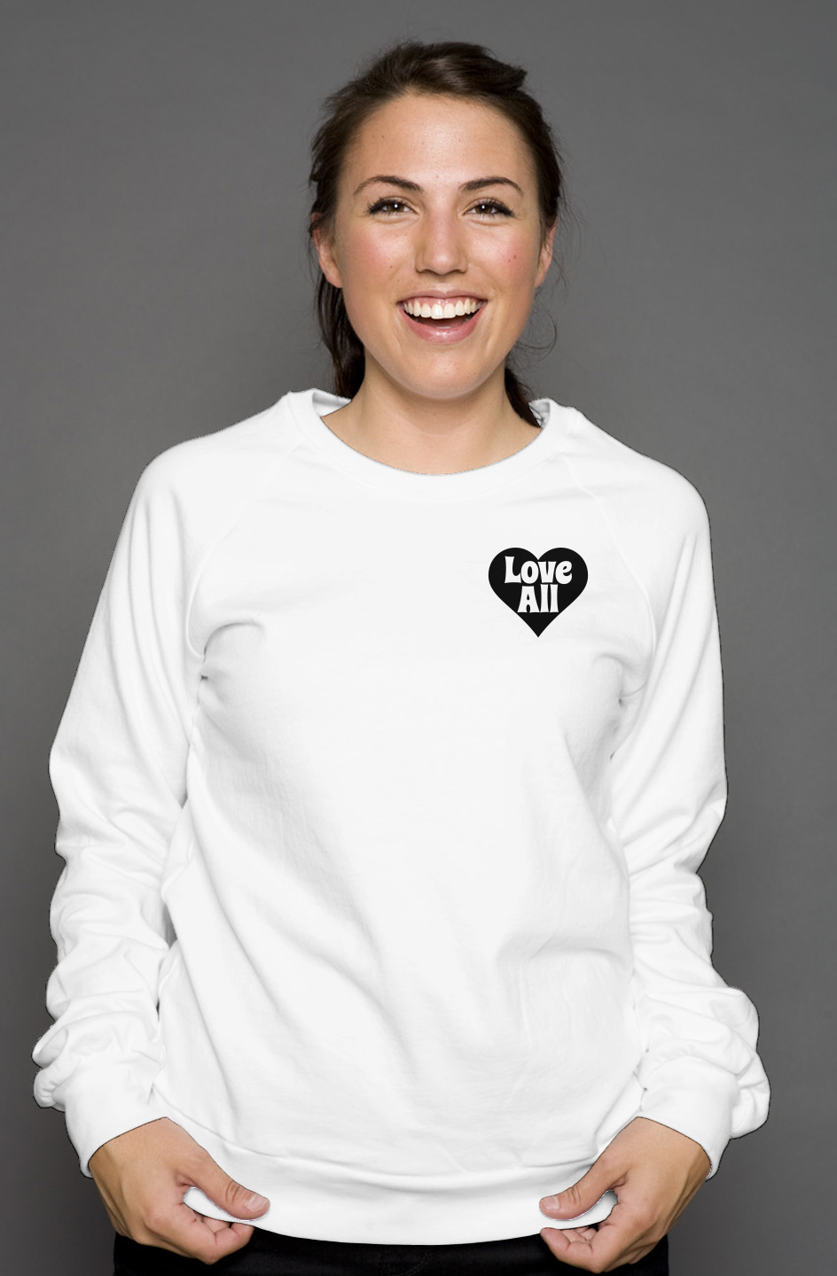 Woman wearing a white sweatshirt with a black heart design on a gray background