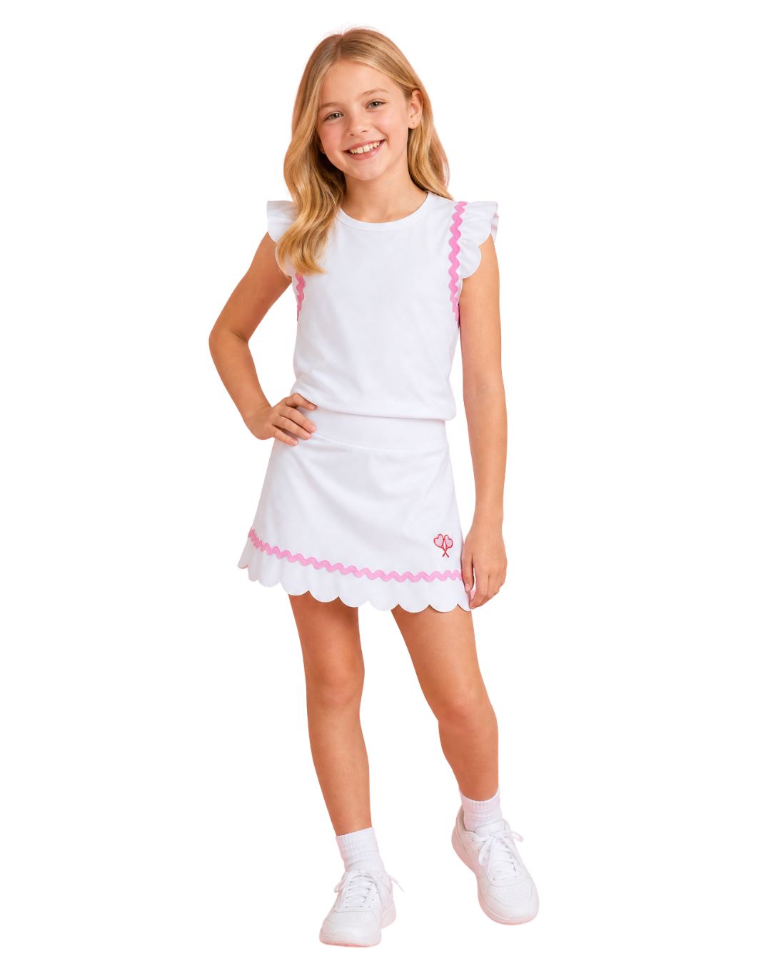 Young girl wearing a white dress with pink trim on a white background
