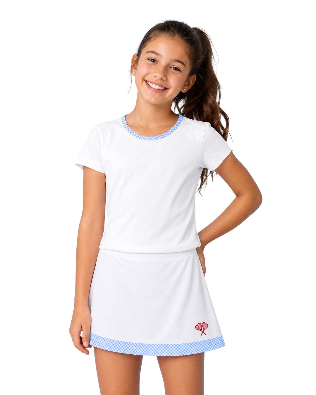 Young girl wearing a white tennis outfit with blue accents on a white background