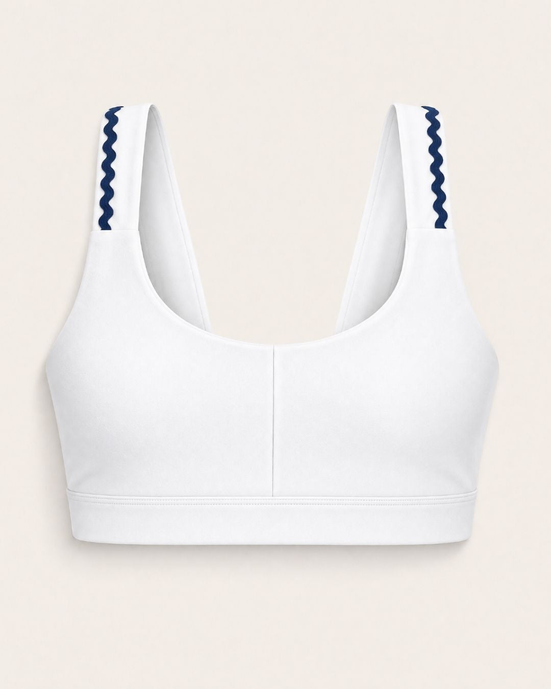 White sports bra with blue accents on a beige background