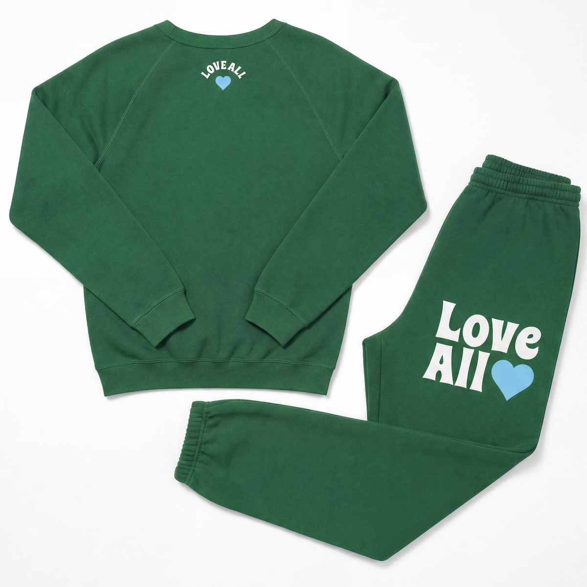 A matching green sweatshirt and sweatpants set laid flat on a white background. The sweatshirt has 'LOVE ALL' printed in white with a small light blue heart on the upper back.