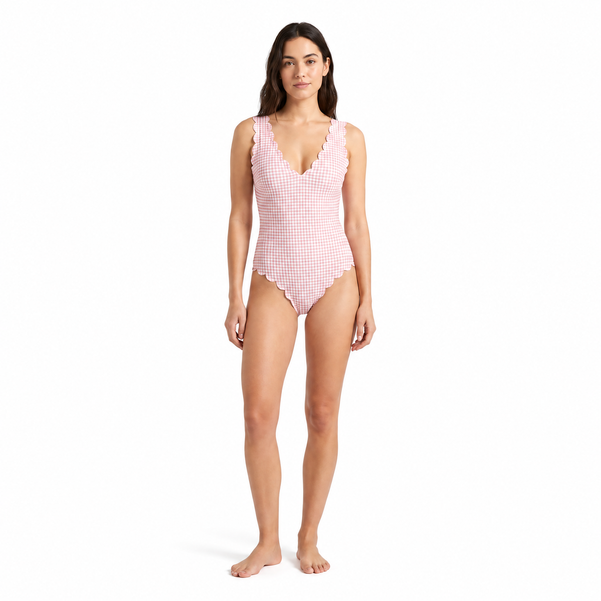 Woman wearing a pink and white gingham one-piece swimsuit on a white background