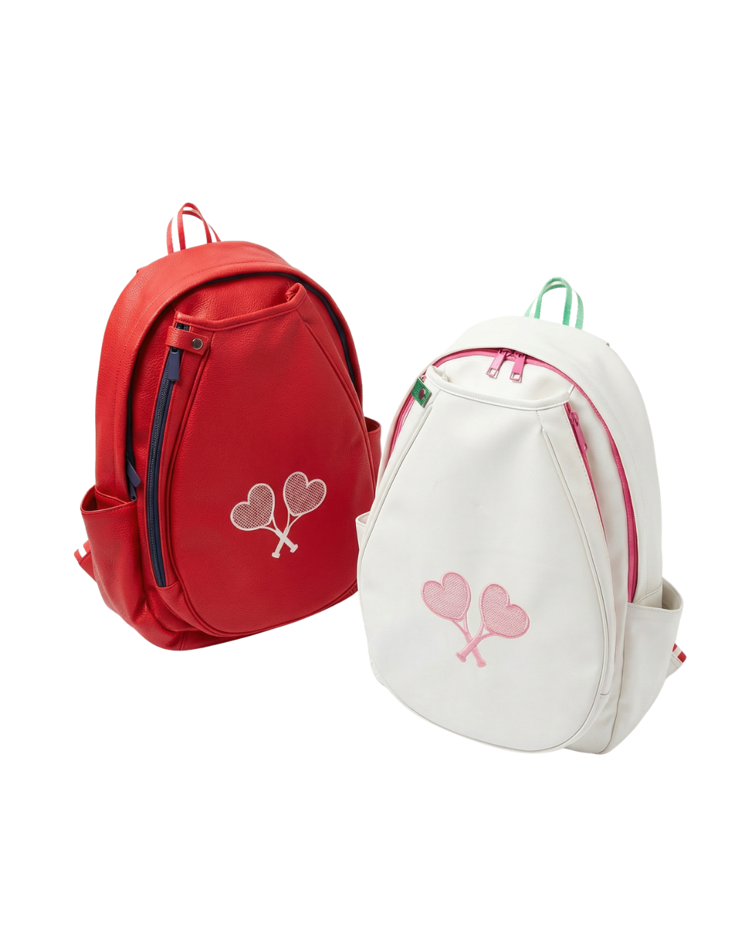 Two small backpacks on a white background: one red with a pink heart motif and blue zipper, and one white with a pink heart motif and green zipper.