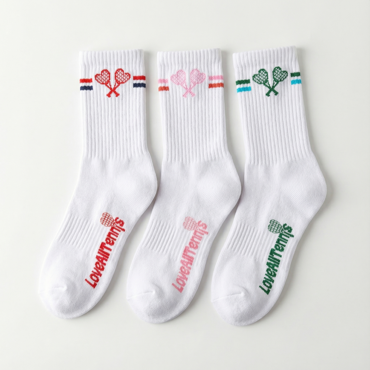Three white socks with colorful designs and text on a light gray background