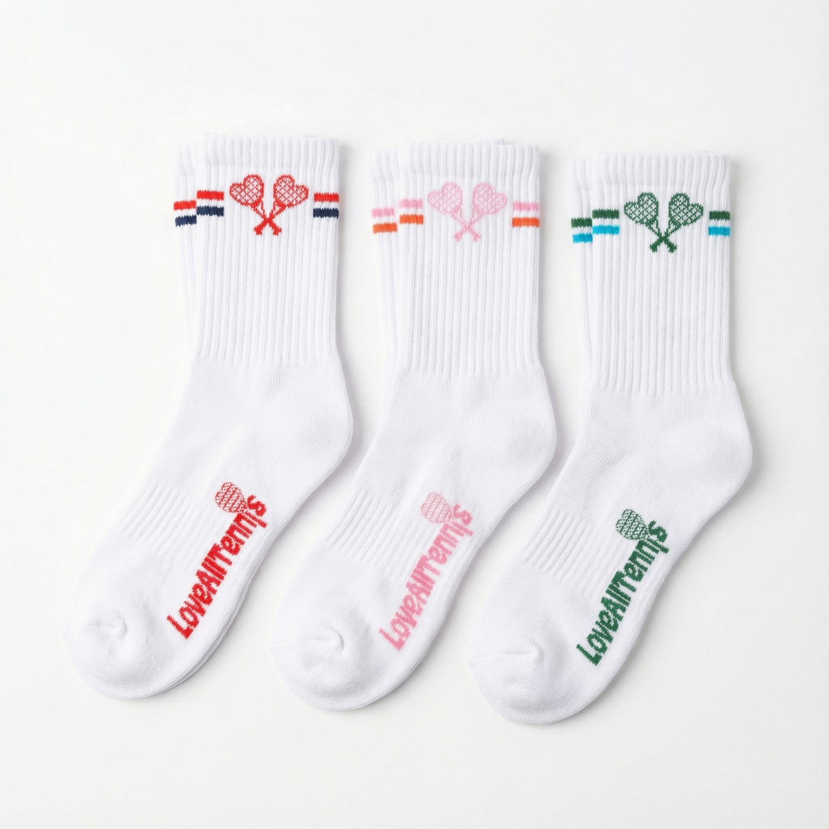 Three white socks with colorful designs and text on a white background