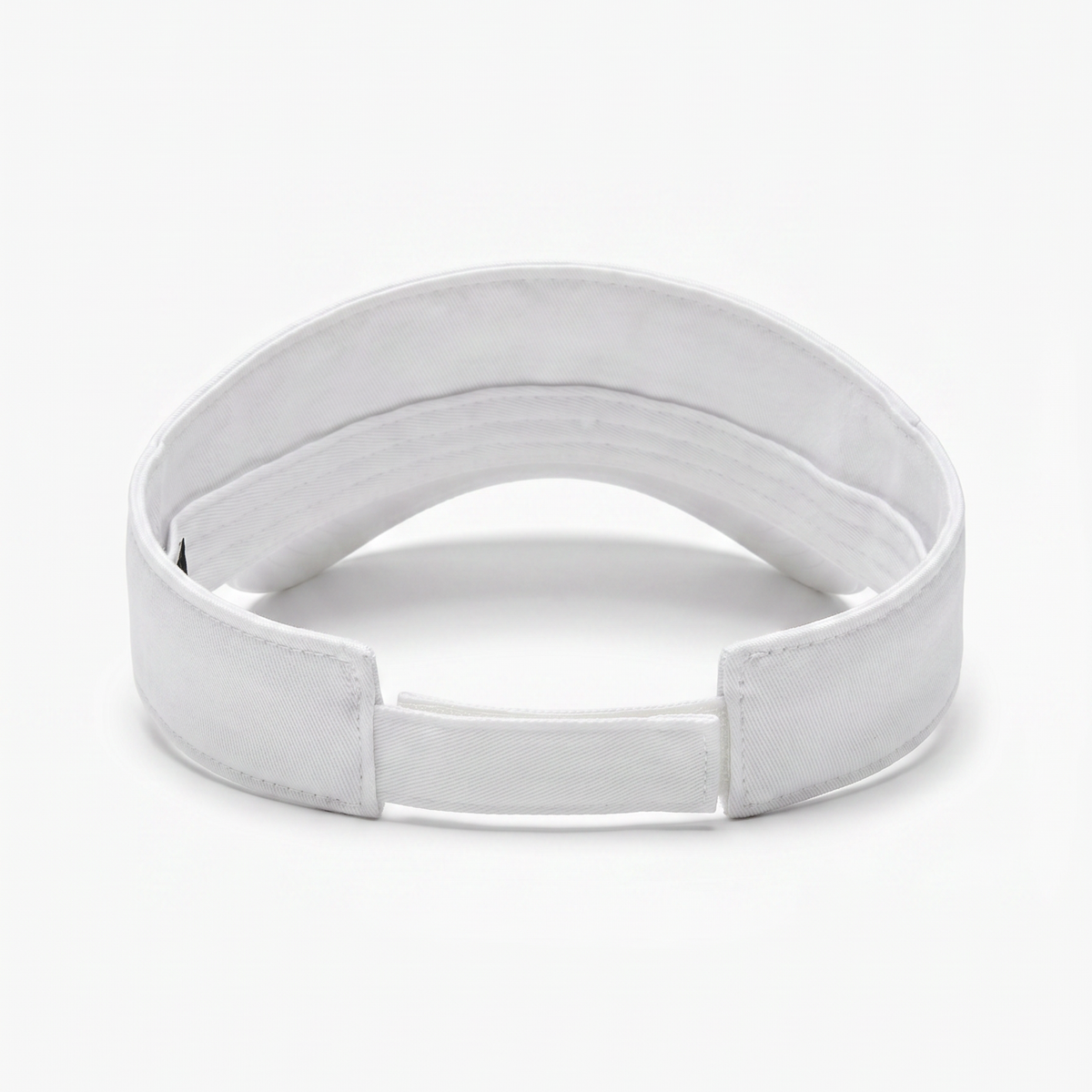 A white fabric visor with an adjustable hook-and-loop closure, photographed on a seamless white background.