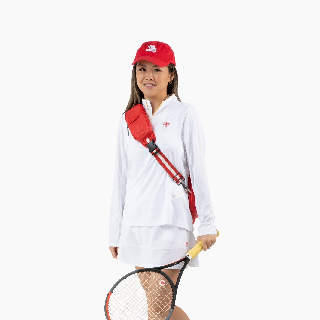 Person wearing a white outfit with a red cap and holding a tennis racket on a white background