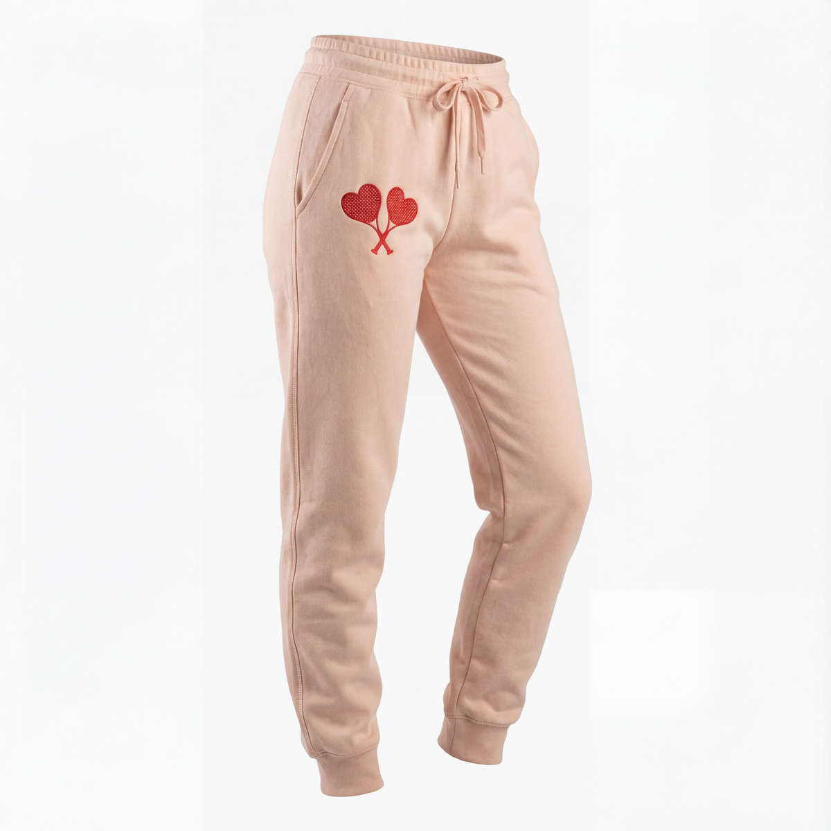 Peach sweatpants with a heart design on a white background
