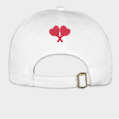 White cap with red heart design on a light gray background