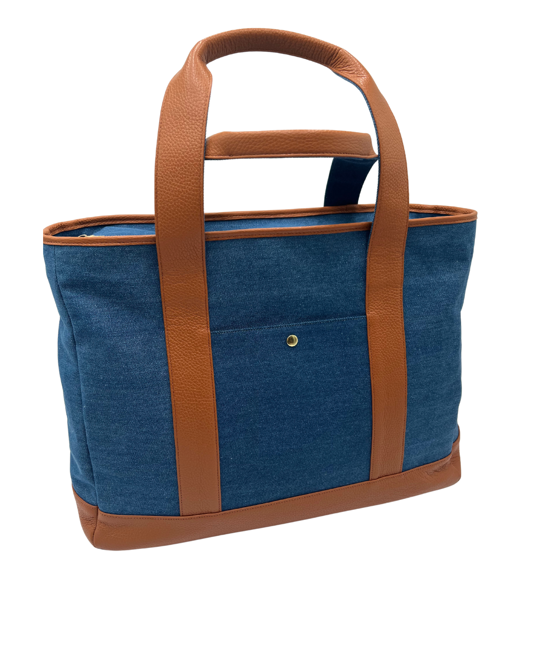 A blue denim tote bag with brown leather handles, trim, and base, shown on a plain white background.