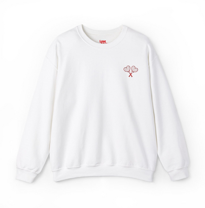 White sweatshirt with tennis racket and ball design on a white background