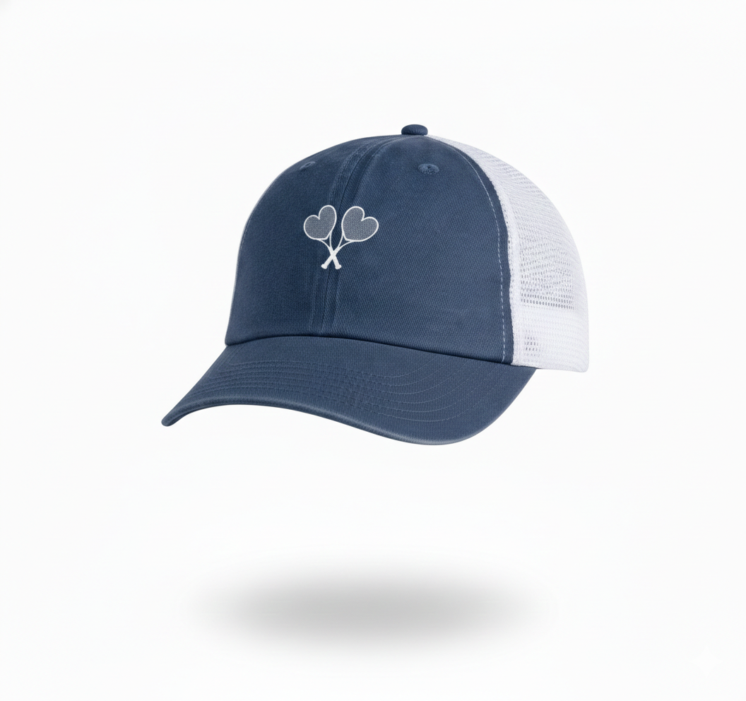 Blue and white trucker hat with heart shaped tennis rackets crossing on the front set on a white background