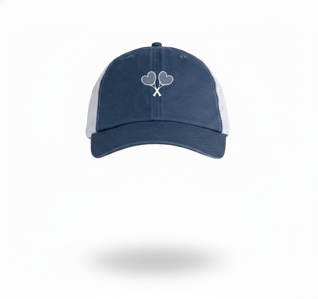 Blue and white trucker hat with heart shaped tennis rackets crossing on the front set on a white background