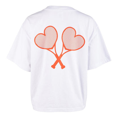 White t-shirt with red heart-shaped tennis rackets on a white background