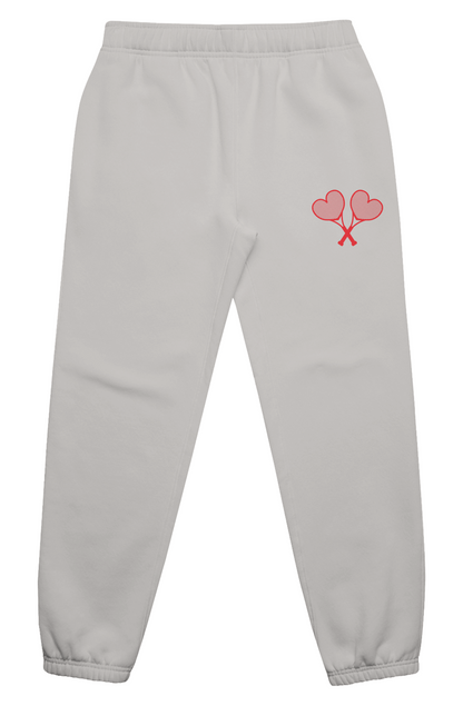 Grey sweatpants with red logo on flat white background