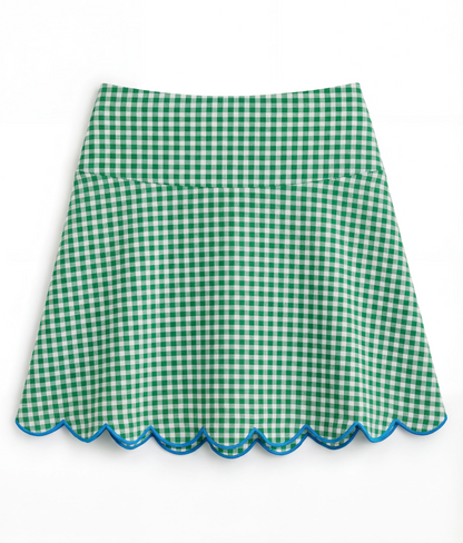 Green gingham skirt with scalloped edge on a white background