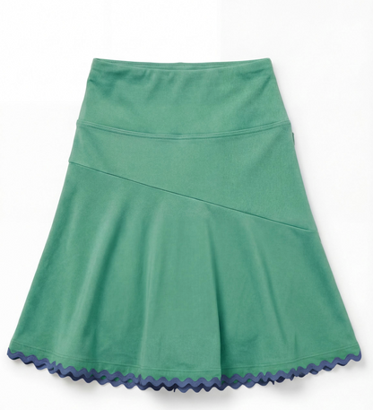 Green athletic skirt with navy scalloped hem on a flat white background