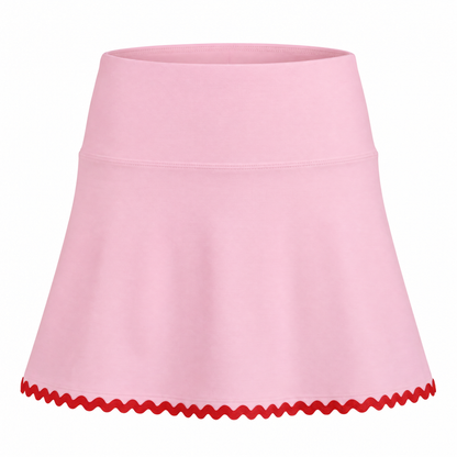 A light pink athletic skirt with a red wavy scalloped trim along the hem, shown against a plain white background.