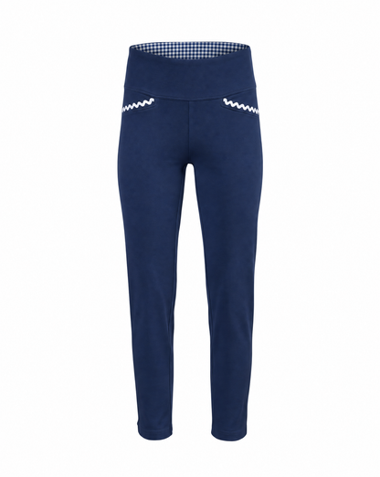 A pair of navy blue cropped pants with a wide waistband, featuring a blue and white gingham pattern lining inside the waistband and white zigzag embroidered details on the front of each leg.