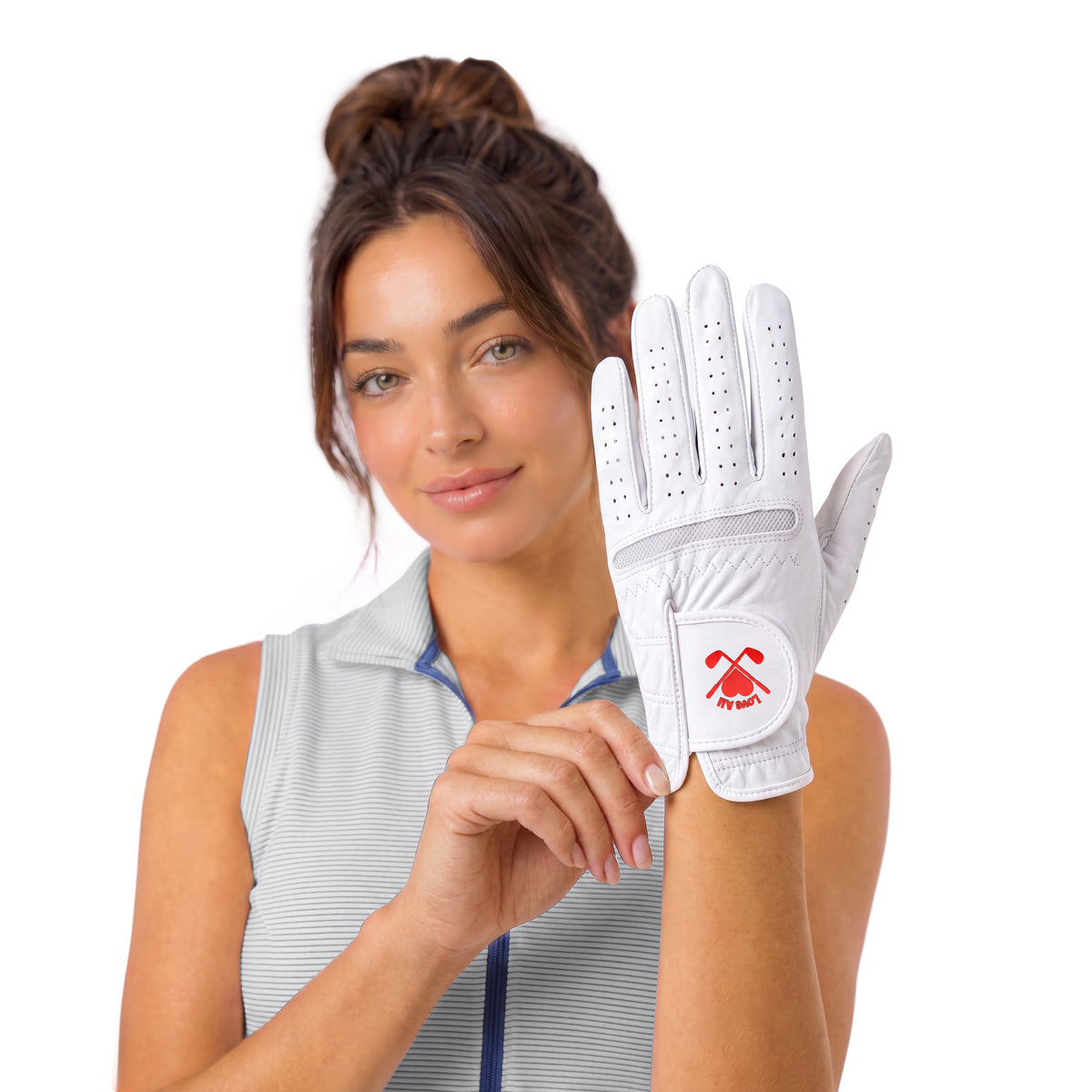 A woman wearing a white golf glove with a red logo, holding it up against a clean white background.