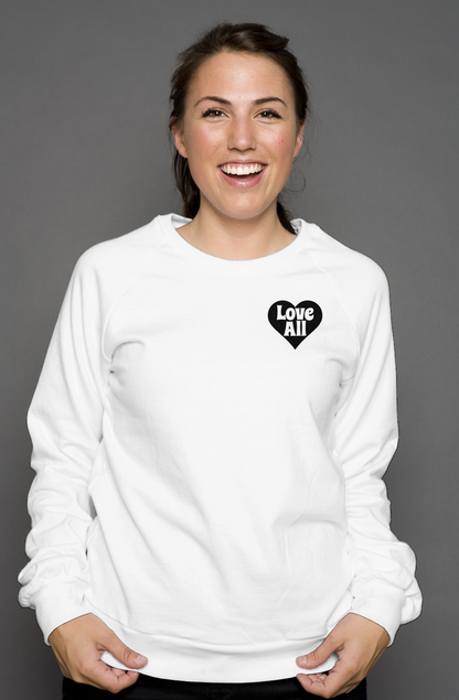 Woman wearing a white sweatshirt with a black heart design on a gray background
