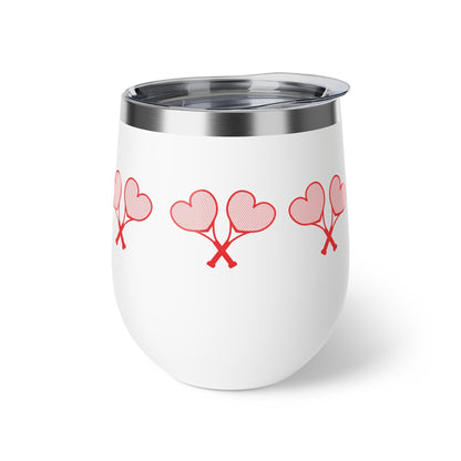 White tumbler with red heart designs on a white background