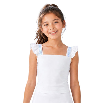 Young girl wearing a white dress with blue trim on a white background