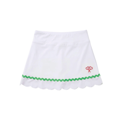 White skirt with green trim and red heart design on a white background