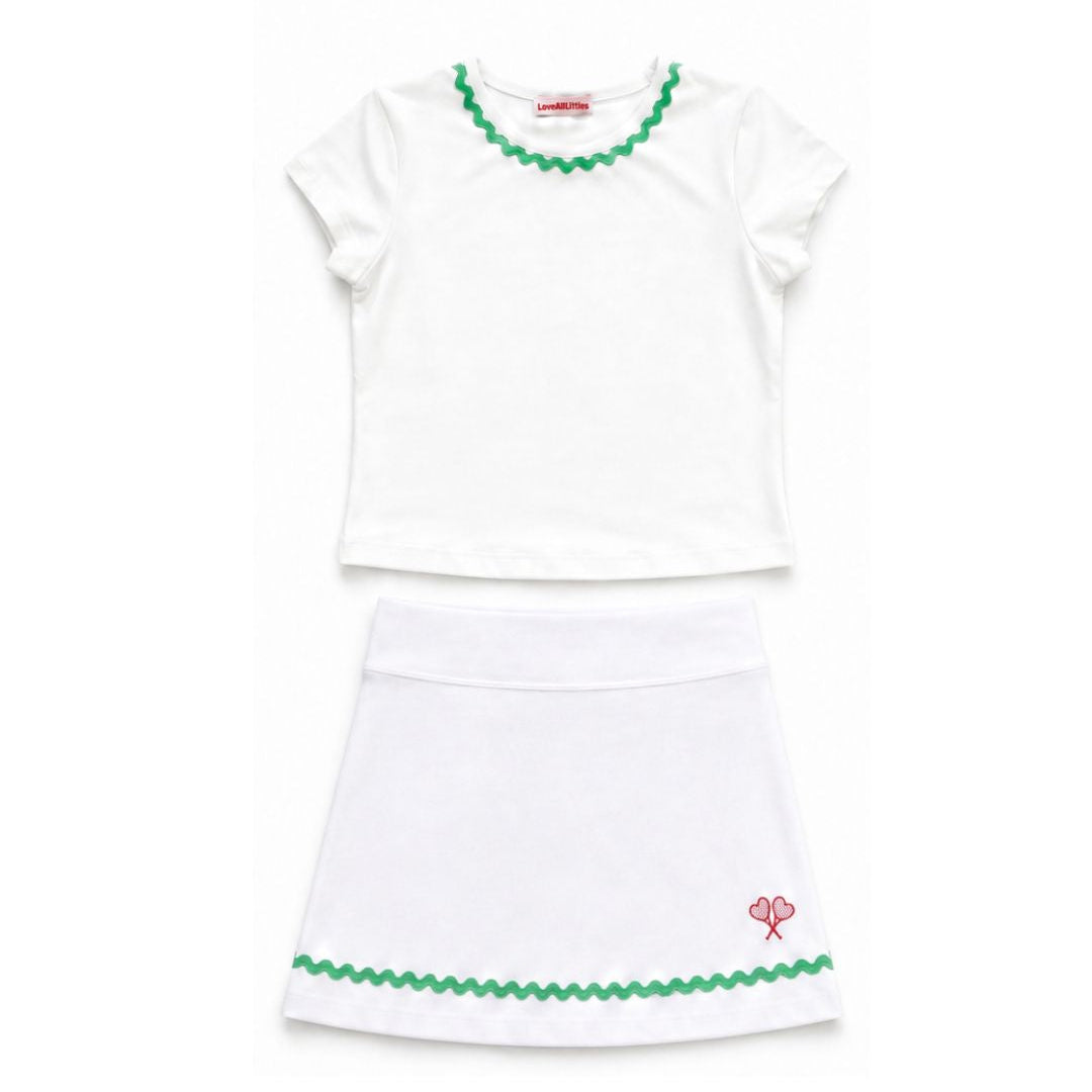 White top and skirt set with green trim on a white background