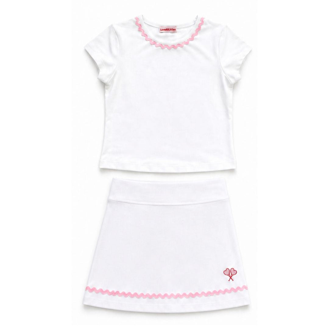 White top and skirt with pink trim on a white background