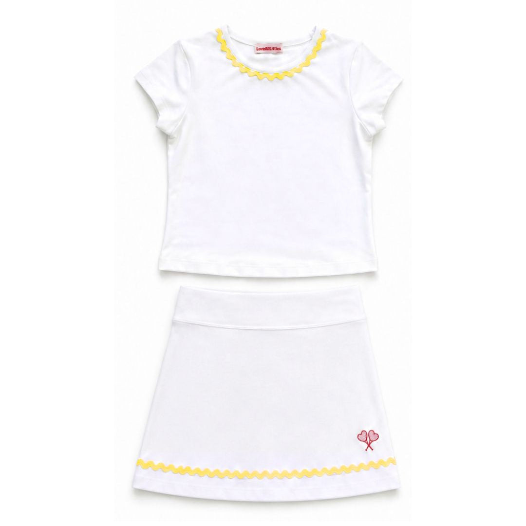 White top and skirt with yellow trim on a white background