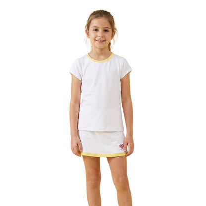 Young girl wearing a white outfit with yellow trim on a white background