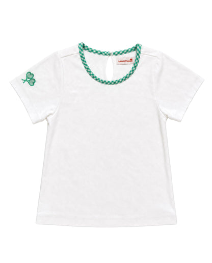 A white short-sleeve baby tee with a green and white checkered trim around the crew neck and a green shamrock on the left sleeve, shown on a plain white background.