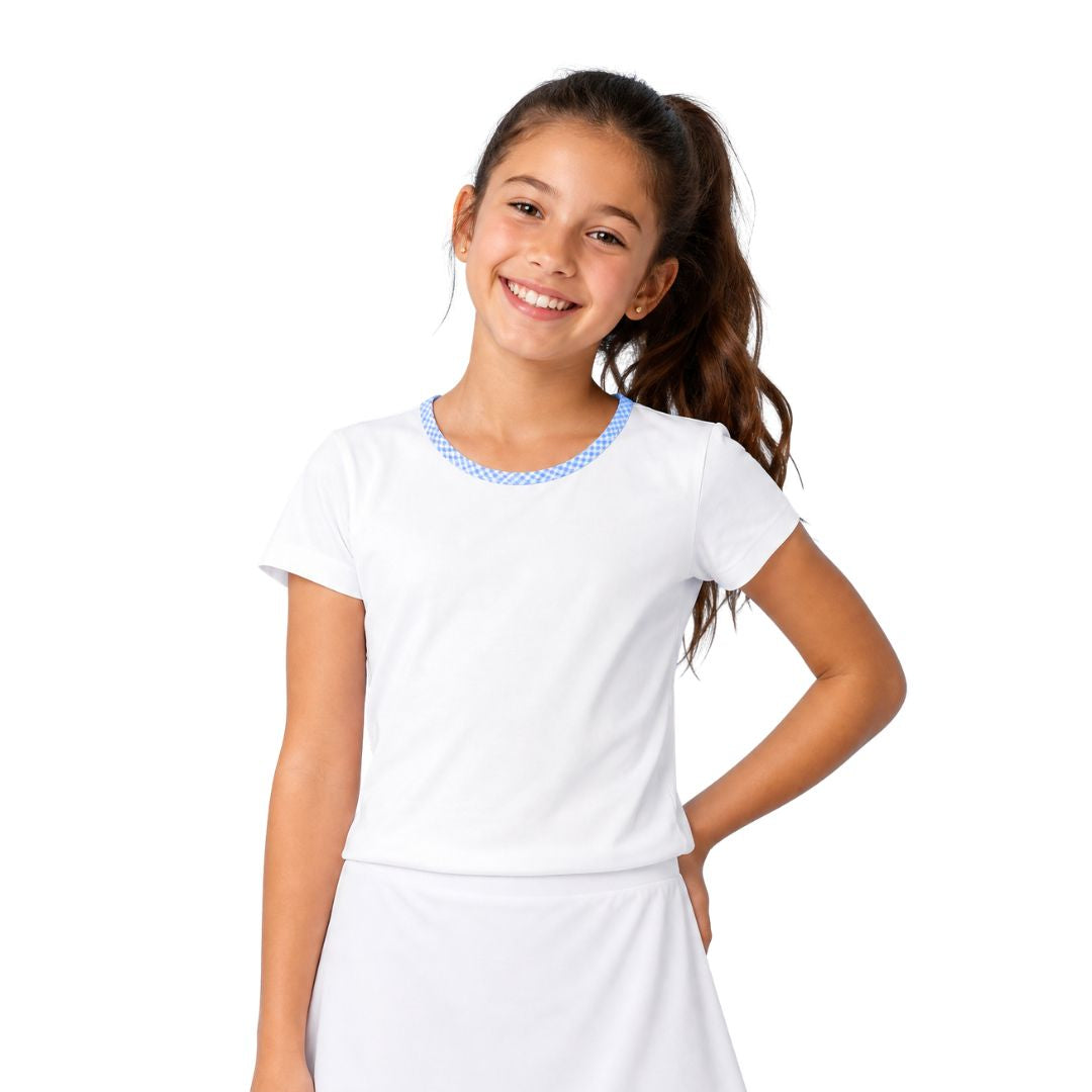 Young girl wearing a white tennis outfit with blue accents on a white background