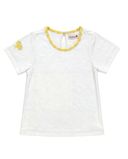 A white short-sleeve baby tee with a yellow braided trim around the crew neck and a small yellow embroidered crossed heart tennis rackets on the left sleeve, shown flat on a white background.