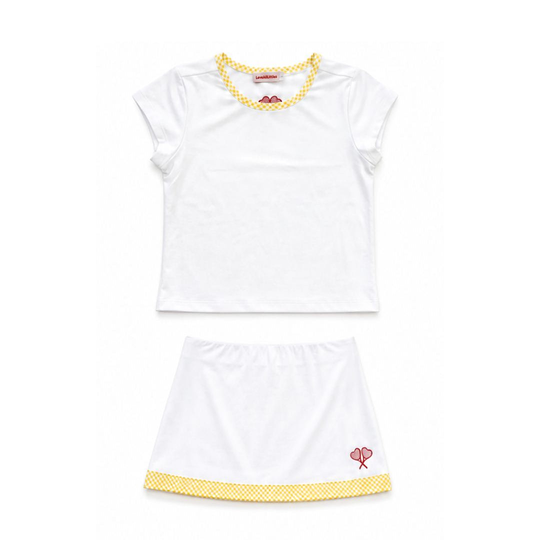 White tennis outfit with yellow accents on a white background