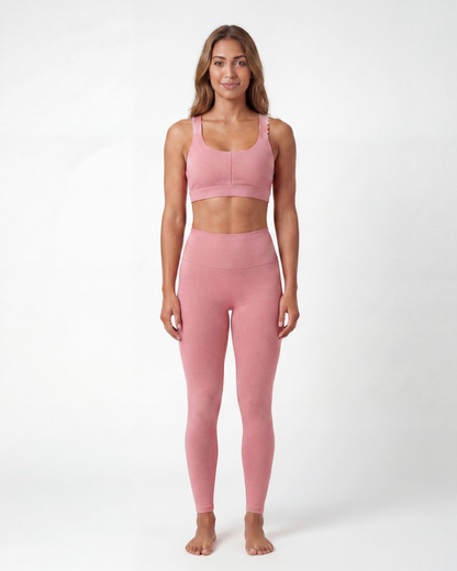 Woman wearing a pink athletic outfit on a white background