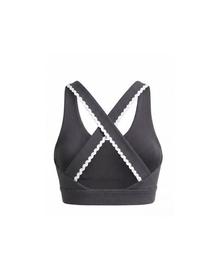 Grey sports bra with white trim on a white background