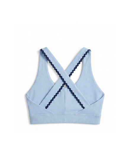 Light blue sports bra with navy trim on a white background