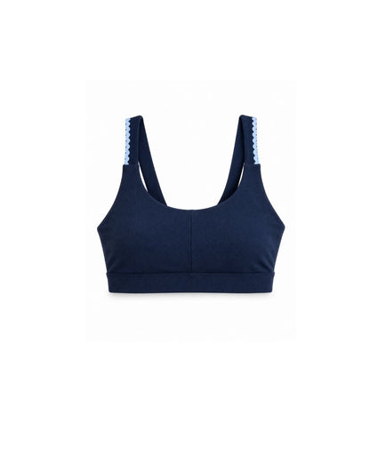 Navy blue sports bra with light blue trim on a white background