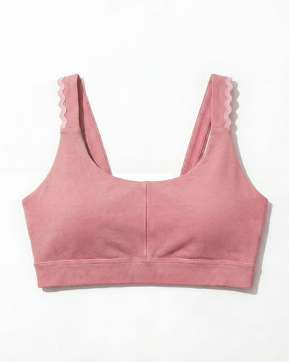 Pink sports bra with pink trim on a white background