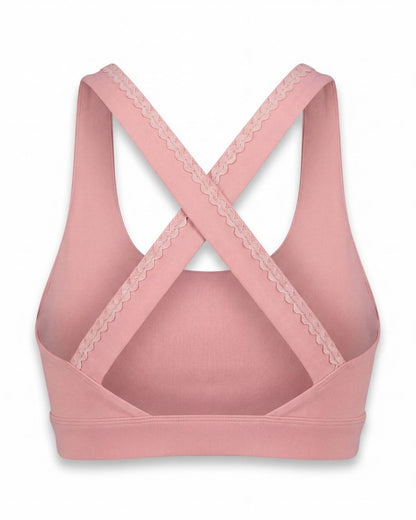 Pink sports bra with lace details on a white background