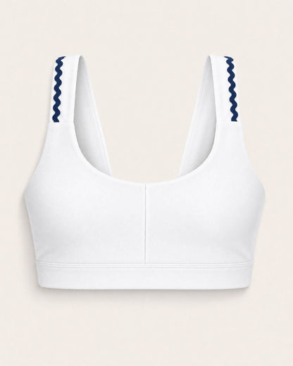 White sports bra with blue accents on a beige background