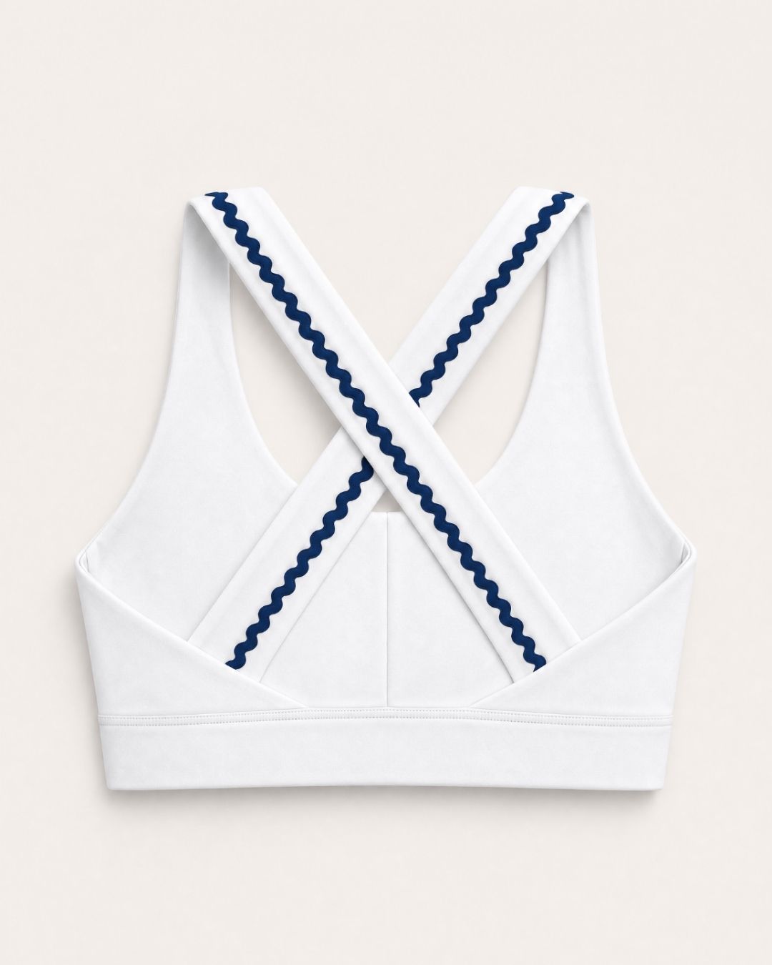 White sports bra with blue trim on a light beige background