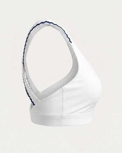White sports bra with blue trim on a light gray background