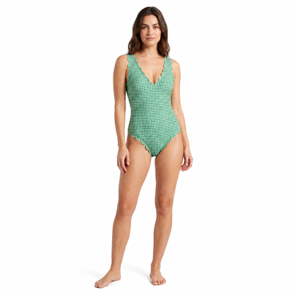 Woman wearing a green and white gingham swimsuit on a white background