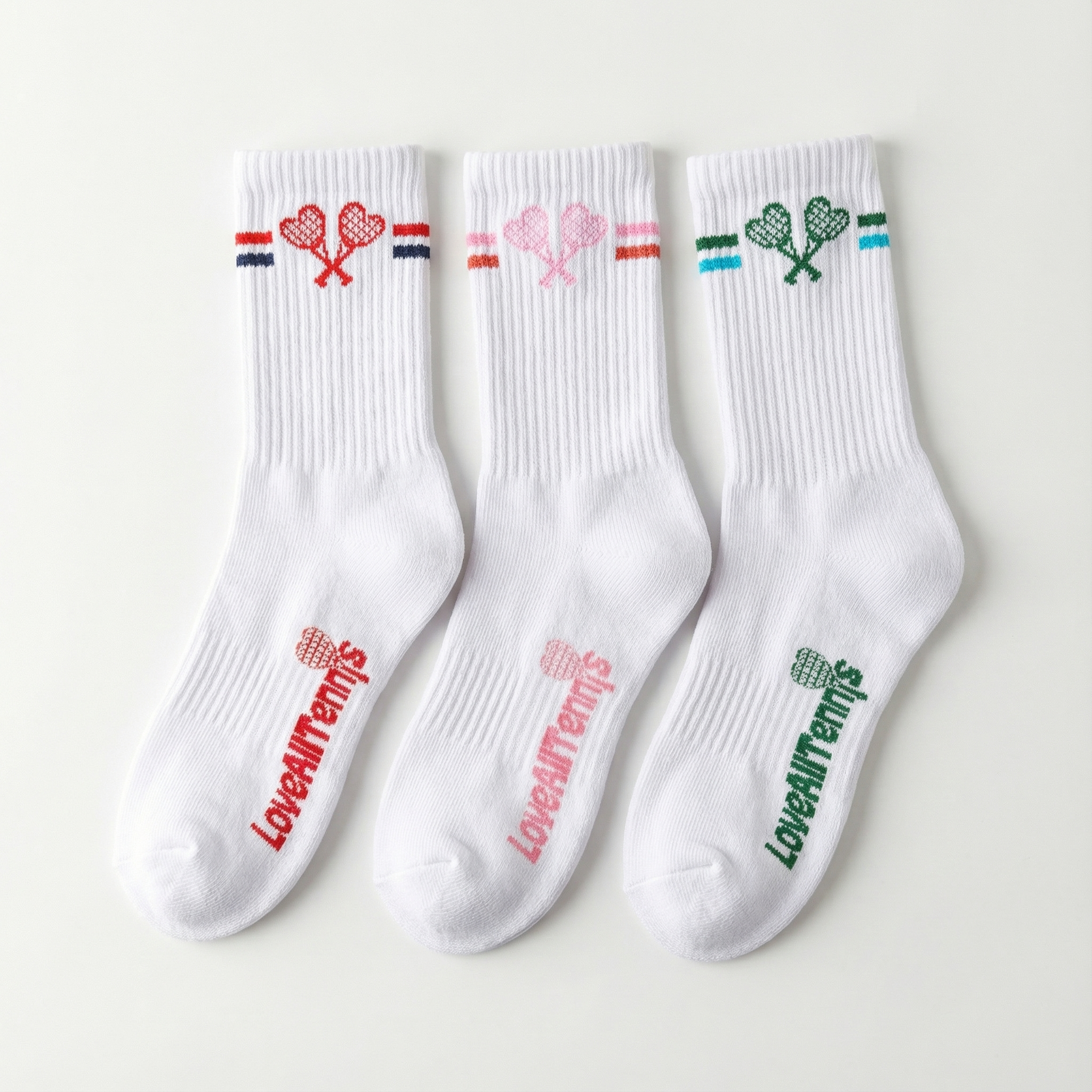 Three white socks with colorful designs and text on a light gray background
