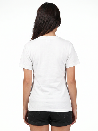 A woman viewed from behind wearing a plain white short-sleeve crewneck t-shirt and black shorts against a white studio background.